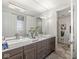 Dual vanity bathroom with elegant fixtures and a view into the water closet at 720 S Rangeline Rd # 601, Carmel, IN 46032