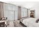 Airy bedroom boasts natural light, modern curtains, and a view into another room at 720 S Rangeline Rd # 601, Carmel, IN 46032