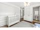 Bright Bedroom with hardwood floors and view into an ensuite bath at 720 S Rangeline Rd # 601, Carmel, IN 46032