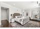 Primary bedroom featuring a king bed, sitting area, and hardwood flooring at 720 S Rangeline Rd # 601, Carmel, IN 46032