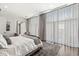 Bright bedroom with large windows, sheer curtains, a full-length mirror, and a comfortable seating area at 720 S Rangeline Rd # 601, Carmel, IN 46032