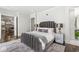 Elegant bedroom features a luxurious upholstered bed, stylish lighting, and a cozy rug at 720 S Rangeline Rd # 601, Carmel, IN 46032