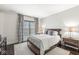 Bedroom with a plush bed, wood floors, patterned drapes and dark stained nightstands at 720 S Rangeline Rd # 601, Carmel, IN 46032