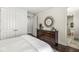 Bedroom with a dresser, hardwood floors and view into an ensuite bath at 720 S Rangeline Rd # 601, Carmel, IN 46032