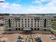 Exterior aerial view of a luxury apartment building with street parking, manicured landscaping, and a grand entrance at 720 S Rangeline Rd # 601, Carmel, IN 46032