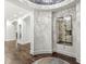 Elegant entryway with a decorative mirror, smooth textured walls, hardwood floors, and arched doorway at 720 S Rangeline Rd # 601, Carmel, IN 46032