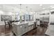 Gourmet kitchen with a large island, stainless steel appliances, white cabinets, and open access to the dining area at 720 S Rangeline Rd # 601, Carmel, IN 46032