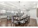 Open floor plan showcases kitchen with blue backsplash and dining table at 720 S Rangeline Rd # 601, Carmel, IN 46032