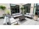 This luxurious outdoor patio offers comfortable seating around a wood coffee table, perfect for entertaining or relaxing outdoors at 720 S Rangeline Rd # 601, Carmel, IN 46032