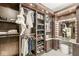 Custom walk-in closet boasting stylish storage solutions, including shelves, drawers, and a vanity area at 720 S Rangeline Rd # 601, Carmel, IN 46032