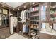 Well-organized walk-in closet with custom shelving, hanging rods, and built-in drawers at 720 S Rangeline Rd # 601, Carmel, IN 46032