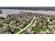 Aerial view of the community and neighborhood with houses, trees, and a lake at 8845 Otter Cove Cir, Indianapolis, IN 46236