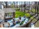 Inviting outdoor deck with comfortable seating, firepit, and views of the landscaped backyard and surrounding greenery at 8845 Otter Cove Cir, Indianapolis, IN 46236