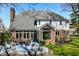 Patio with outdoor seating, lush landscaping, and expansive windows, offering a serene outdoor living space at 8845 Otter Cove Cir, Indianapolis, IN 46236