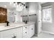 Contemporary bathroom with double sinks, black fixtures, white cabinets, and a large mirror, offering modern convenience at 8845 Otter Cove Cir, Indianapolis, IN 46236