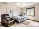 Cozy bedroom with a comfortable recliner chair, and window with natural light at 8845 Otter Cove Cir, Indianapolis, IN 46236