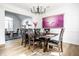 Dining room with hardwood floors is bright and inviting, boasting a large table with seating and modern art at 8845 Otter Cove Cir, Indianapolis, IN 46236