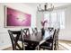 Bright dining room features a modern chandelier, art, hardwood floors, and a table set for six at 8845 Otter Cove Cir, Indianapolis, IN 46236