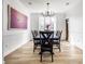 Elegant dining room features a modern chandelier, art, a large table with seating for six, and hardwood floors at 8845 Otter Cove Cir, Indianapolis, IN 46236