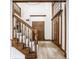 Elegant foyer featuring hardwood floors, a staircase, and ample natural light, creating a grand entrance at 8845 Otter Cove Cir, Indianapolis, IN 46236