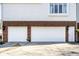 Spacious three-car garage with clean white doors and adjacent landscaping, ensuring ample parking at 8845 Otter Cove Cir, Indianapolis, IN 46236