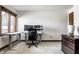 Bright home office featuring dual monitors, a modern desk, and natural light at 8845 Otter Cove Cir, Indianapolis, IN 46236