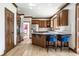Spacious kitchen features custom wood cabinetry, a central island with seating, and stainless steel appliances at 8845 Otter Cove Cir, Indianapolis, IN 46236