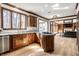 Open concept kitchen with dark wood cabinets, stainless appliances, island cooktop, and view to the living room at 8845 Otter Cove Cir, Indianapolis, IN 46236