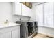 Well-equipped laundry room featuring new washer and dryer and sink with modern faucet at 8845 Otter Cove Cir, Indianapolis, IN 46236