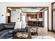 Spacious living room with hardwood floors offering an open concept layout into the kitchen with barstool seating at 8845 Otter Cove Cir, Indianapolis, IN 46236