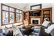 Cozy living room features a fireplace with custom built-ins and large windows offering lots of natural light at 8845 Otter Cove Cir, Indianapolis, IN 46236