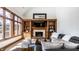 Bright living room featuring a fireplace, built-in shelving, large windows, and stylish decor at 8845 Otter Cove Cir, Indianapolis, IN 46236