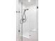 Modern shower with glass doors, white tile, and sleek fixtures, offering a clean and refreshing experience at 8845 Otter Cove Cir, Indianapolis, IN 46236