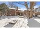 Expansive backyard view showing covered deck, mature trees, and large brick home, creating a serene and inviting atmosphere at 925 Forest Dr, Anderson, IN 46011
