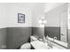 A well lit half bathroom with a sleek sink and modern fixtures at 925 Forest Dr, Anderson, IN 46011