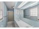 An aqua bathroom with a shower and double sink at 925 Forest Dr, Anderson, IN 46011