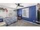 A blue bedroom with two windows and a bed at 925 Forest Dr, Anderson, IN 46011
