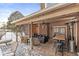 Inviting covered deck boasting a brick wall with a mounted TV and outdoor seating, perfect for relaxation at 925 Forest Dr, Anderson, IN 46011