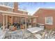 Charming covered deck offers multiple seating areas, table, and grill, creating an ideal outdoor entertaining space at 925 Forest Dr, Anderson, IN 46011