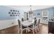Bright dining room with wainscoting, hardwood floors, and a stylish chandelier at 925 Forest Dr, Anderson, IN 46011