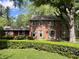Beautiful two-story brick home with a well-maintained lawn and mature trees in the background at 925 Forest Dr, Anderson, IN 46011
