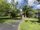 A two-story brick house with mature trees, and blacktop drive in park-like setting at 925 Forest Dr, Anderson, IN 46011