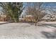 Beautiful brick two-story home featuring mature trees, manicured landscaping, and a snow-covered front yard at 925 Forest Dr, Anderson, IN 46011