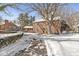 Charming brick home with a snow-covered yard and driveway, showcasing classic architecture and curb appeal at 925 Forest Dr, Anderson, IN 46011