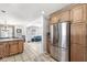 Open kitchen with granite countertop island, stainless steel appliances, and custom wood cabinetry at 925 Forest Dr, Anderson, IN 46011