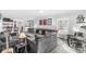 Spacious living room complete with a bar area, shuffleboard, and lounge seating, perfect for entertaining and relaxation at 925 Forest Dr, Anderson, IN 46011