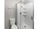 Bathroom featuring modern shower with glass door, shelving, and neutral paint at 102 Plummer Ave, Bargersville, IN 46106