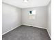 Vacant bedroom features gray walls, carpet, and a window at 102 Plummer Ave, Bargersville, IN 46106