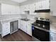 Kitchen featuring white cabinets, stainless steel appliances, and a view to the back yard at 102 Plummer Ave, Bargersville, IN 46106