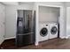 Laundry area with new front load machines and stainless steel fridge at 102 Plummer Ave, Bargersville, IN 46106